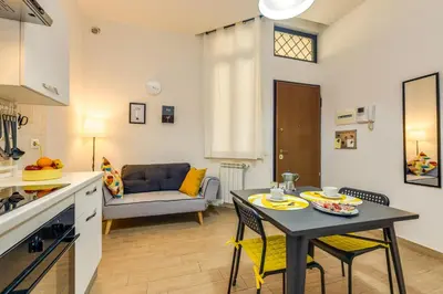 a kitchen and living room with a table and chairs at Roger apt in Rome