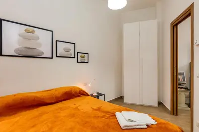 a bedroom with a bed with a stack of towels at Roger apt in Rome