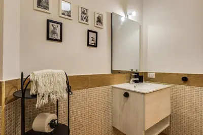a bathroom with a sink and a mirror at Roger apt in Rome