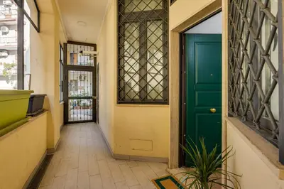 a hallway with a green door and a plant at Roger apt in Rome