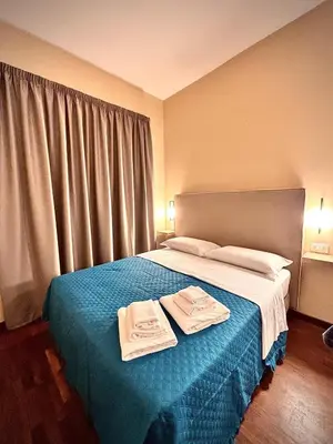 a bedroom with a bed with two towels on it at Le Vie di San Pietro Guest House in Rome