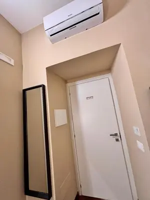 a bathroom with a white door and a mirror at Le Vie di San Pietro Guest House in Rome
