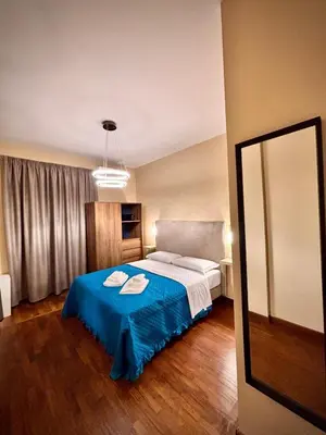 a bedroom with a bed with a blue blanket at Le Vie di San Pietro Guest House in Rome