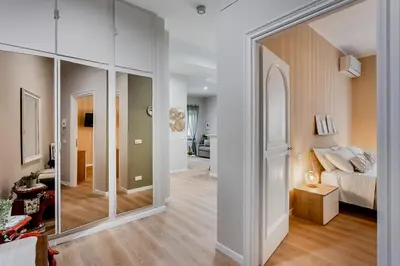 a living room with a large glass door leading to a bedroom at VATICAN VIBE Apt in Rome