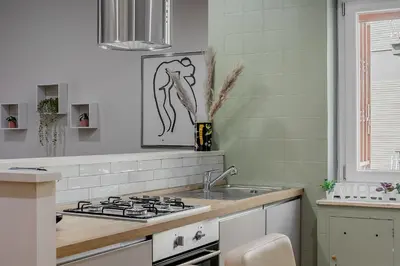 a kitchen with a sink and a stove at VATICAN VIBE Apt in Rome