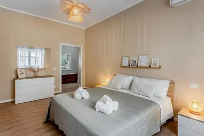 a bedroom with a large bed with towels on it at VATICAN VIBE Apt in Rome