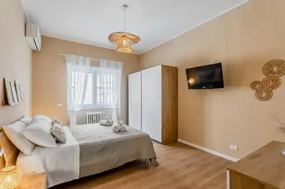a bedroom with a bed and a tv on the wall at VATICAN VIBE Apt in Rome