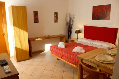 a bedroom with a bed and a table with plates on it at Appartamento con terrazza vicino al Vaticano in Rome