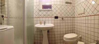 a bathroom with a toilet and a sink at Appartamento con terrazza vicino al Vaticano in Rome