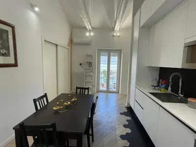 a kitchen and dining room with a table and chairs at Veio Loft in Rome