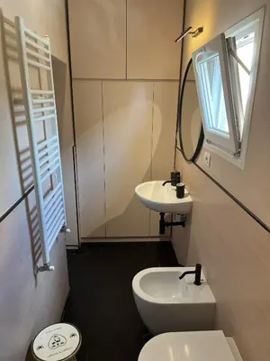 a bathroom with a sink and a toilet and a mirror at Veio Loft in Rome