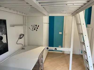 a room with a bunk bed and a ladder at Veio Loft in Rome