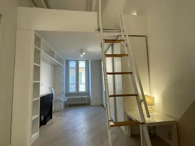 a loft bed in a room with a ladder at Veio Loft in Rome