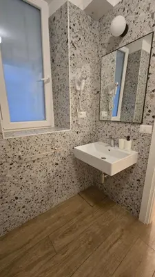a bathroom with a sink and a mirror at Domus Regis Rooms in Rome