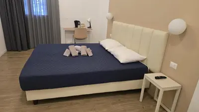 a bedroom with a bed with two towels on it at Domus Regis Rooms in Rome