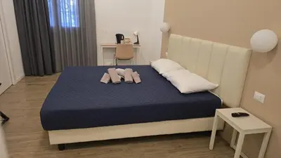 a bedroom with a bed with two towels on it at Domus Regis Rooms in Rome
