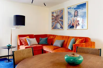 a living room with an orange couch and a table at ​Easylife - Elegante trilocale in Piazza Navona in Rome
