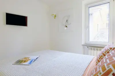 a bedroom with a bed with a magazine on it at ​Easylife - Elegante trilocale in Piazza Navona in Rome