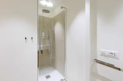 a shower with a glass door in a bathroom at ​Easylife - Elegante trilocale in Piazza Navona in Rome