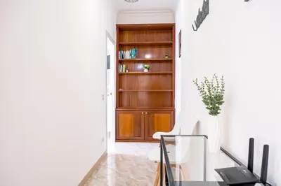 a hallway with a desk and a book shelf at Elegantis Labicana Apartment - Few steps from the Colosseum in Rome