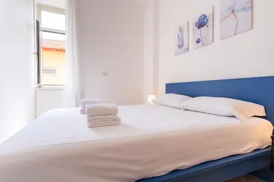 a bed with two towels sitting on top of it at Elegantis Labicana Apartment - Few steps from the Colosseum in Rome