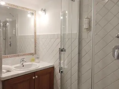 a bathroom with a sink and a glass shower at Dimora Roma Eterna, vacation & business in Rome