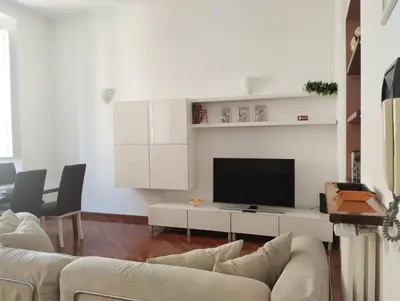 a living room with white furniture and a flat screen tv at Dimora Roma Eterna, vacation & business in Rome