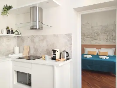 a kitchen with a sink and a bed in a room at Dimora Roma Eterna, vacation & business in Rome