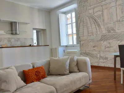 a living room with a couch and a drawing on the wall at Dimora Roma Eterna, vacation & business in Rome