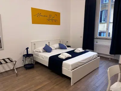 a bedroom with a bed with blue pillows on it at Manara10 Apart Blu1 in Rome