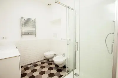 a bathroom with a toilet and a sink and a shower at Manara10 Apart Blu1 in Rome