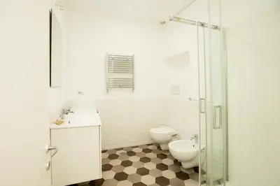 a bathroom with a toilet and a sink and a shower at Manara10 Apart Blu1 in Rome
