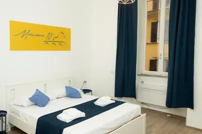 a bedroom with a bed with blue and white sheets at Manara10 Apart Blu1 in Rome