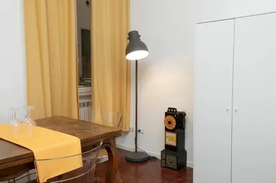 a dining room with a table and a lamp at Manara10 Apart giallo2 in Rome