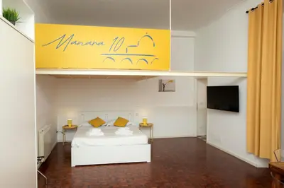 a room with a white bed and a yellow sign at Manara10 Apart giallo2 in Rome