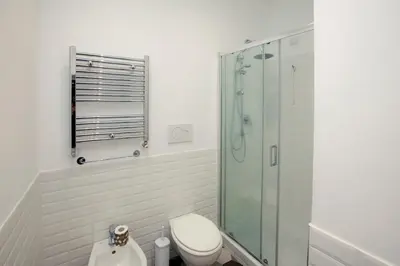a bathroom with a toilet and a glass shower at Manara10 Apart giallo2 in Rome
