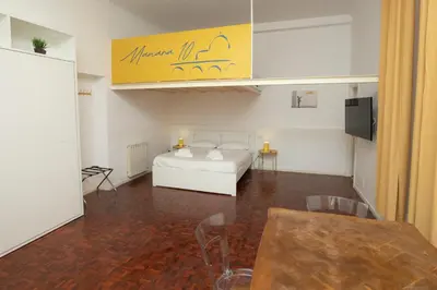 a hotel room with a bed and a table and chairs at Manara10 Apart giallo2 in Rome
