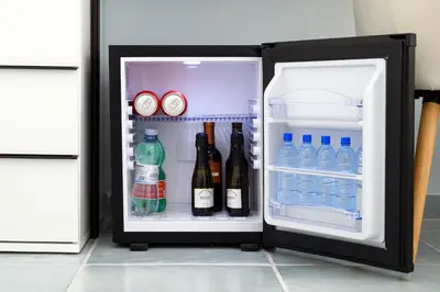 an open refrigerator with bottles of water and drinks at Magnoliahome Suites at the Vatican in Rome