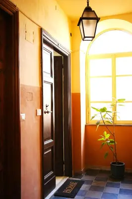 a hallway with a door and a window and a plant at Emma and Livia's Vatican Suite 2 in Rome