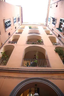a building with a bunch of balconies with plants in it at Emma and Livia's Vatican Suite 2 in Rome