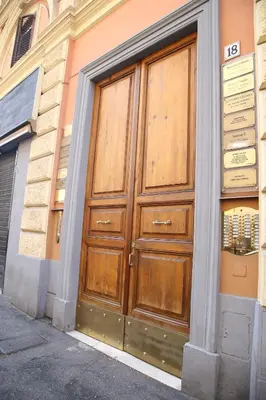 a large wooden door on the side of a building at Emma and Livia's Vatican Suite 2 in Rome