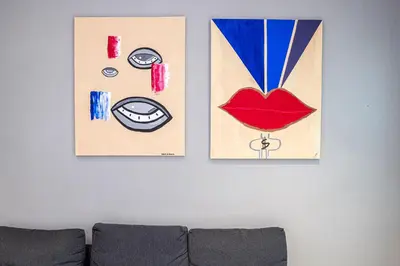 three pieces of art on a wall above a couch at Casa Sistina in Rome