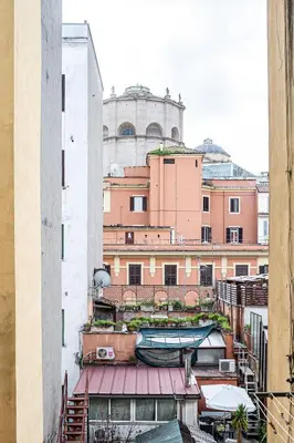 a view of a building with a boat on a balcony at Casa Sistina in Rome