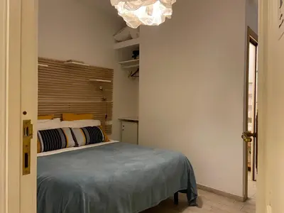 a bedroom with a bed and a chandelier at Room of Arts in Rome
