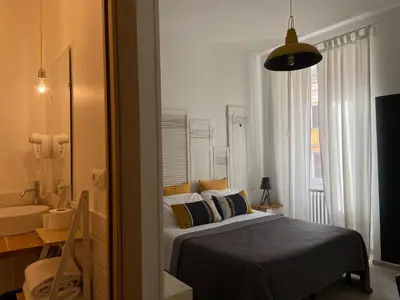 a bedroom with a bed and a bathroom with a sink at Room of Arts in Rome