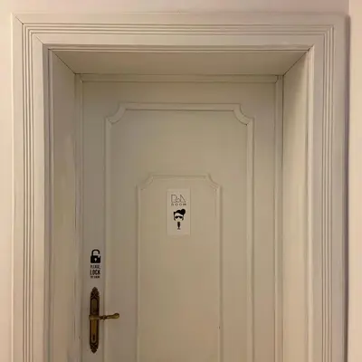a white door with a sign on it at Room of Arts in Rome