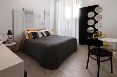 a bedroom with a bed and a table and chairs at Room of Arts in Rome