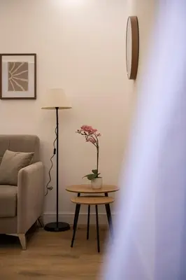 a living room with a table and a chair and a lamp at Appartamento Roma - Bredi Home in Rome