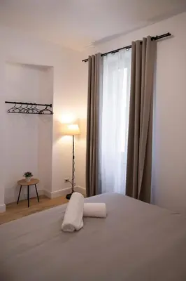 a bedroom with a white bed with a window at Appartamento Roma - Bredi Home in Rome