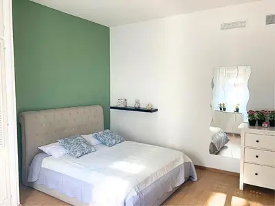 a bedroom with a bed and a green wall at Terracito! in Rome
